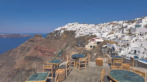 Santorini cafe terrace overlooking caldera and white village. Stock Footage 337536133