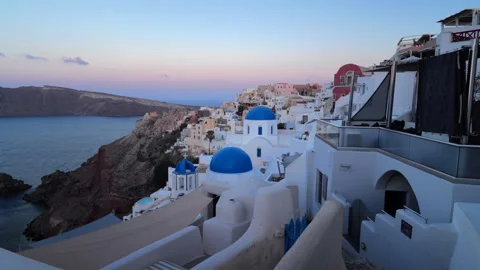 Santorini cliffside view with iconic blue domes in Oia at soft sunset light Stock-Footage 324622658