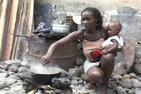 Sao Tome, Africa: Woman cooks over open fire Stock Footage