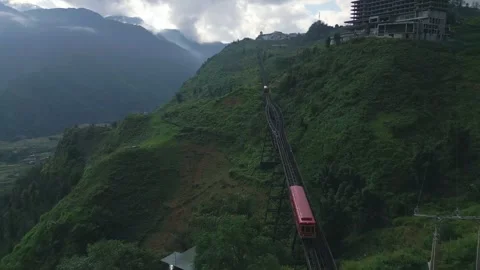 Sapa mountain train exiting tunnel hillside aerial view Stock Footage 336487052