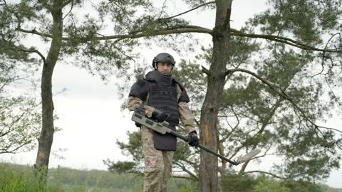 Sapper combat engineer deminer with a mine detector in his hands Video stock 259956162