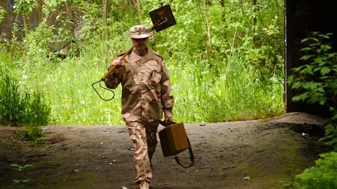 Sapper with mine detector comes to ruined building Stock Footage 94358962