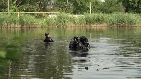 Sappers check lake for explosive devices after fighting in Ukraine Stock Footage 314148714