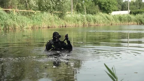 Sappers check lake for explosive devices after fighting in Ukraine Stock Footage 314148723