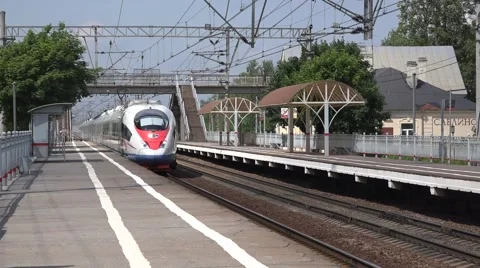 Sapsan high speed train to Moscow runs along a station platform Stock Footage 64574572