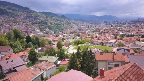 Sarajevo aerial closing down to graveyard and passing towards to city Stock Footage 103007684