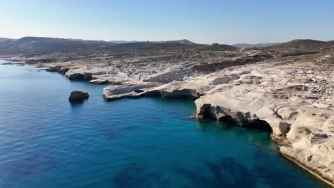 Sarakiniko white volcanic cliffs and eroded sea caves along the coast of Milos Stock Footage 346296060