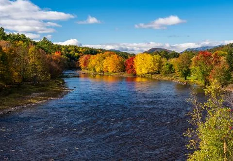 Saranac river flows through multi-colored fall landscape in Adirondacks NY Stock Photos