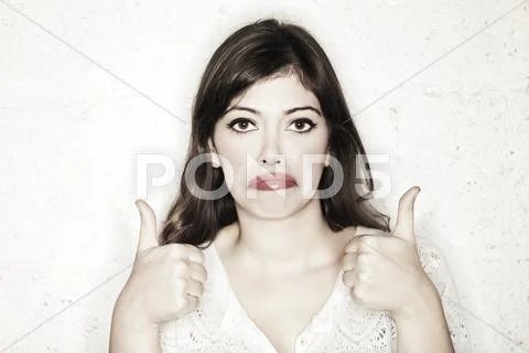 Sarcastic thumbs up sad woman Stock Photos