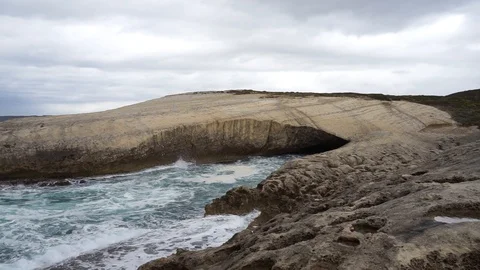 S'Archittu cliffs in a grey mistral storm Stock Footage 105349204