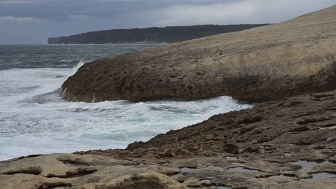 S'Archittu cliffs in a grey mistral storm Stock Footage 105349215