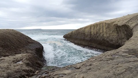 S'Archittu cliffs in a grey mistral storm Stock Footage 105349262