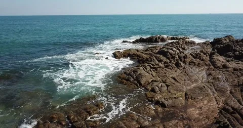 Sardinia: aerial view of waves breaking along the rocky coast 動画素材 155354667