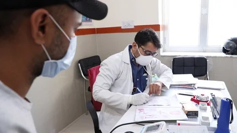 SARS-CoV-2, New strain of Coronavirus, Doctor wearing respirator write Stock Footage 126745040