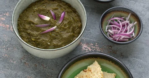 Sarson ka Saag, Makki ki Roti and seasonings: ginger and shallots. Stock Footage 296904125