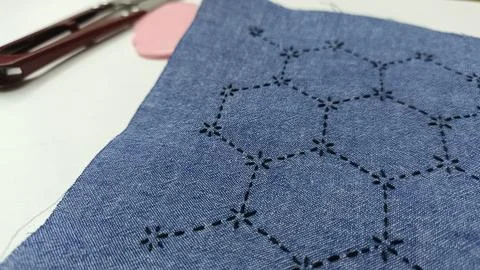 Sashiko embroidery process close up with black thread.  Stock Photos