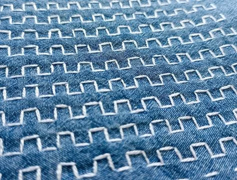 Sashiko stitching pattern on blue fabric Stock Photos