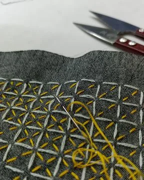 Sashiko Stitching in Progress on Gray Fabric with Yellow Thread. 스톡 사진