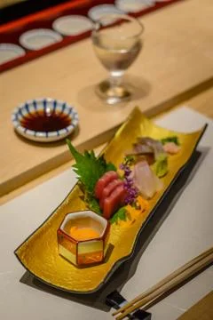 Sashimi raw fish course with sake and tuna and sea urchin uni Stock Photos