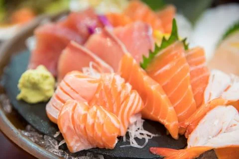 Sashimi set with different fresh fish sliced on plate Stock Photos