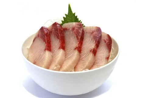 Sashimi sliced hamachi, placed on ice in a bowl. Stock Photos
