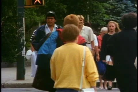 SASKATOON, SASKATCHEWAN, 1990, Crowd on sidewalk in Saskatoon Stock Footage 20485443