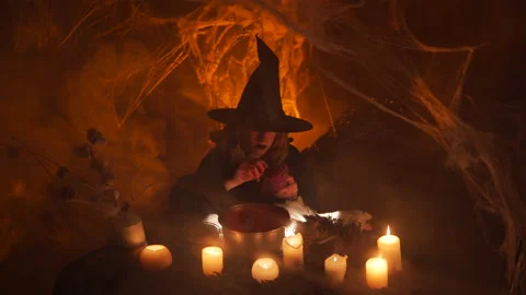 Сasts a magic. Pokes pin into a voodoo doll. Halloween concept. 스톡 동영상 163388226