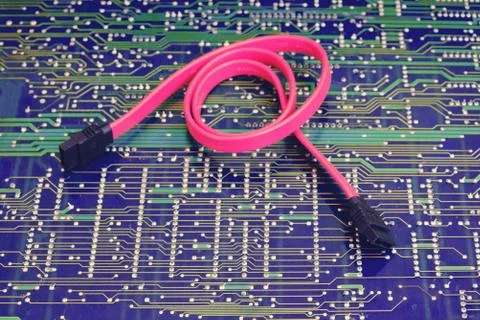 Sata cable wire against electronic circuit board Stock Photos