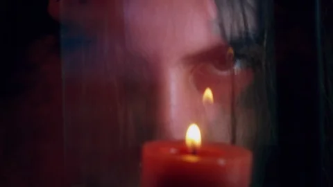 Satanic Face Staring Behind Candle Burning On Red Smoke Stock Footage 123851055