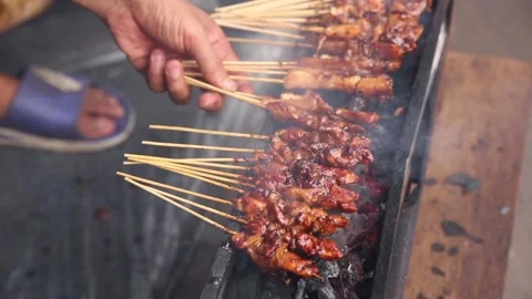 Satay grilled while holding a hand fan 動画素材 270347317