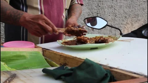 Satay vendors is marinating pork satay Stock Footage 340981789