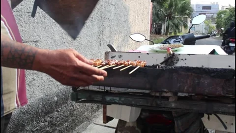 Satay vendors marinating pork satay Stock Footage 340984488