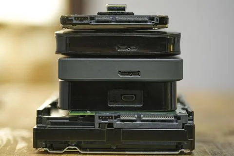 Satck of hdd memory storage devices over dark surface,tech components,usb,memory Stock Photos