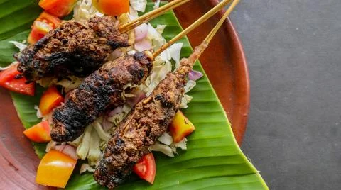 Sate buntel or satay buntel is satay made from minced mutton wrapped in mutto Stock Photos