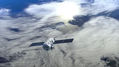 The satellite appears in the frame and flies away from camera. Satellite is Stock Footage 72681425