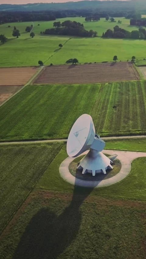 Satellite communication ground station in the middle of green fields, vertical Stock Footage 283338204