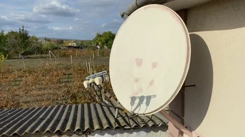 Satellite dish antenna attached on house facade in village. Stock Footage 219281655