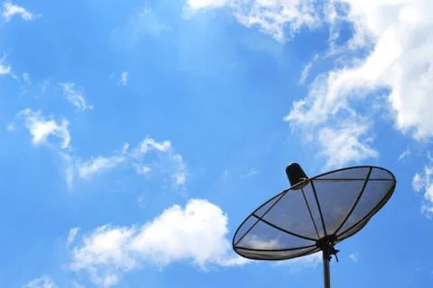 Satellite dish on the background of clouds and sky Stock Photos