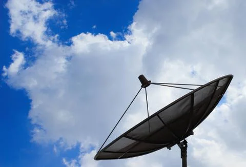Satellite dish on the background of clouds and sky Stock Photos