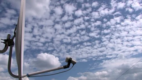 Satellite dish on the background of the sky and floating white clouds, time laps Stock Footage 82481957