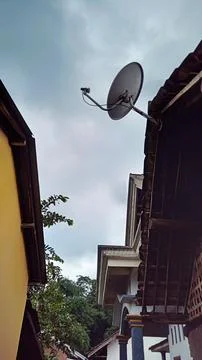 Satellite Dish on Building Rooftop Stock Photos
