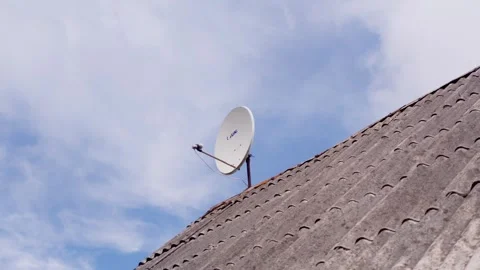 Satellite dish mounted on old slate house roof in Daugavpils countryside Latvia Vídeo Stock 344355170