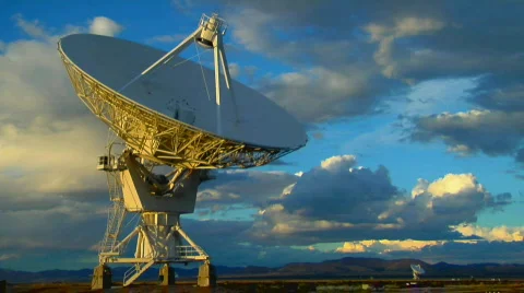 A satellite dish moves in time lapse against a beautiful sky. Stock Footage 554261