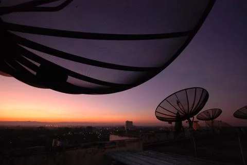Satellite dish at sunset Stock Photos