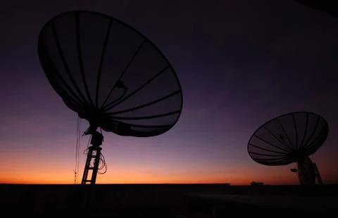 Satellite dish at sunset Stock Photos