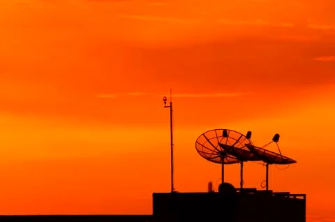 Satellite dish at sunset Stock Photos