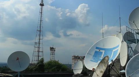Satellite dish, tower and flying bird on blue sky background Stock Footage 34870310