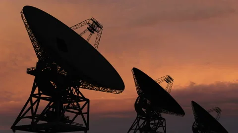 Satellite dishe moving in time-lapse against a sunset sky. Stock Footage