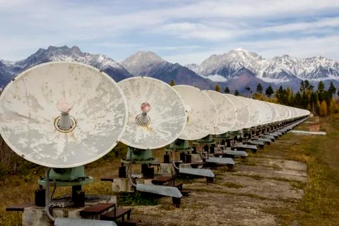 Satellite dishes in the background of mountains located in the forest Stock Photos