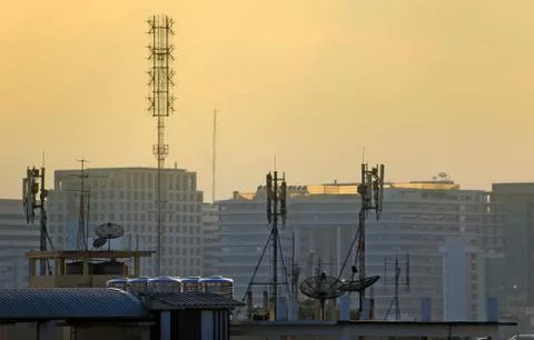 Satellite dishes on rooftops Stock Photos